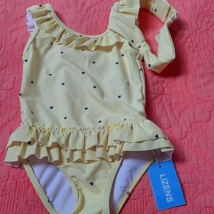 Absolutely adorable toddler girl's swimsuit. Ruffles around the Botto and neck